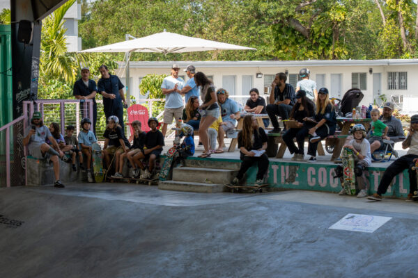 Audience watches skateboarders from the stands during skate event at park. Audience watches skateboarders from the stands during skate event at park.